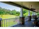 Outdoor porch boasts stone and white pillars with ceiling fan and views of the lawn at 6919 Mount Zion Rd, Waco, GA 30182