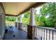 Spacious porch featuring stone pillars and decorative railing overlooking the lush greenery at 6919 Mount Zion Rd, Waco, GA 30182