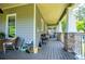 Expansive outdoor porch has seating areas and views of the yard at 6919 Mount Zion Rd, Waco, GA 30182