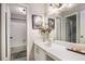 Bathroom with a shower-tub combo, white vanity, and a large mirror at 8740 Roswell Rd # 2G, Atlanta, GA 30350