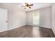 Bedroom with wood-look flooring, a ceiling fan, and a window overlooking the yard at 8740 Roswell Rd # 2G, Atlanta, GA 30350