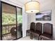 Bright dining area with sliding glass doors leading to a balcony with a wooded view at 8740 Roswell Rd # 2G, Atlanta, GA 30350