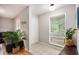 Bright entryway featuring neutral walls, tile flooring, and a large window with natural light at 8740 Roswell Rd # 2G, Atlanta, GA 30350