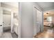 Hallway leading to a bathroom, laundry closet, and bedroom with hardwood floors at 8740 Roswell Rd # 2G, Atlanta, GA 30350
