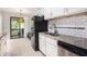 Well-lit kitchen featuring granite counters, stainless steel appliances and stylish tile backsplash at 8740 Roswell Rd # 2G, Atlanta, GA 30350