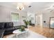 Spacious living room features hardwood floors, modern furnishings, and large windows for natural light at 8740 Roswell Rd # 2G, Atlanta, GA 30350