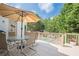 Relaxing back deck with a table and umbrella, overlooking a private backyard with a pool at 113 Gold Bridge Xing, Canton, GA 30114