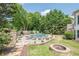 Expansive backyard featuring a pool, patio, fire pit, and beautifully landscaped areas at 113 Gold Bridge Xing, Canton, GA 30114
