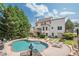Beautiful backyard with a sparkling swimming pool, deck, and outdoor lounge area at 113 Gold Bridge Xing, Canton, GA 30114