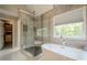 Modern bathroom featuring a glass shower, soaking tub, and stylish tile work at 113 Gold Bridge Xing, Canton, GA 30114
