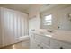 Bright bathroom with a white sink vanity, toilet, light tile floors, and a window for natural light at 113 Gold Bridge Xing, Canton, GA 30114