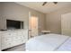 Bedroom featuring a large dresser, television and neutral colored walls at 113 Gold Bridge Xing, Canton, GA 30114