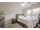 Comfortable bedroom with carpet, ceiling fan, a window letting in natural light, and furniture at 113 Gold Bridge Xing, Canton, GA 30114