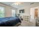 Comfortable bedroom featuring a bed, carpet, a window letting in natural light, and a desk at 113 Gold Bridge Xing, Canton, GA 30114