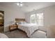 Bright bedroom with a wooden bed frame, neutral carpet, and a large window with outside views at 113 Gold Bridge Xing, Canton, GA 30114