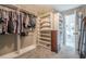 Walk-in closet with custom shelving, hanging racks, and ample storage space at 113 Gold Bridge Xing, Canton, GA 30114
