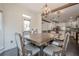 Bright dining area featuring a rustic wooden table, decorative lighting, and hardwood floors at 113 Gold Bridge Xing, Canton, GA 30114