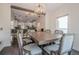 Dining area features a wooden table with seating for six with a view into kitchen and bar at 113 Gold Bridge Xing, Canton, GA 30114