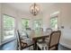 Dining room with large table, seating, and natural light from the surrounding windows at 113 Gold Bridge Xing, Canton, GA 30114