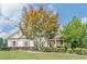 Charming home with a well-manicured lawn and mature trees providing curb appeal and shade at 113 Gold Bridge Xing, Canton, GA 30114