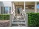 Inviting front entrance with stone stairs, detailed stonework, and a glass-paneled front door at 113 Gold Bridge Xing, Canton, GA 30114