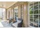 Charming front porch featuring stone accents, seating area, and inviting entryway at 113 Gold Bridge Xing, Canton, GA 30114