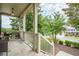 Welcoming front porch with stone flooring, a cozy seating area, and neighborhood views at 113 Gold Bridge Xing, Canton, GA 30114