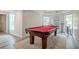 This large game room has a pool table and luxury vinyl plank flooring at 113 Gold Bridge Xing, Canton, GA 30114
