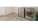 A spacious laundry room complete with modern washer and dryer units and stylish flooring at 113 Gold Bridge Xing, Canton, GA 30114