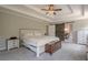 Bright main bedroom features a tray ceiling, sliding barn door, and neutral decor at 113 Gold Bridge Xing, Canton, GA 30114
