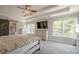 Well-lit main bedroom with carpeting and barn door leading to the main bathroom at 113 Gold Bridge Xing, Canton, GA 30114