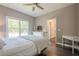 This is a bright main bedroom with a ceiling fan and view of the yard at 113 Gold Bridge Xing, Canton, GA 30114