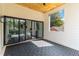 Covered back porch with tile flooring, wood ceiling, large glass sliding doors, and view to living space at 1554 Columbia Cir, Decatur, GA 30032