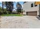 Large backyard with lush green grass and view of the detached garage and home's exterior at 1554 Columbia Cir, Decatur, GA 30032