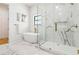 Bright bathroom with a standalone tub and walk-in shower with beautiful marble and brass details at 1554 Columbia Cir, Decatur, GA 30032