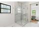 Bathroom boasts glass shower with marble tile surround and view into the bedroom at 1554 Columbia Cir, Decatur, GA 30032