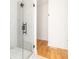 Modern bathroom featuring a glass-enclosed shower, and hardwood flooring in the hallway at 1554 Columbia Cir, Decatur, GA 30032