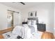 Modern bedroom featuring a barn door to the bathroom, stylish decor, and hardwood floors at 1554 Columbia Cir, Decatur, GA 30032