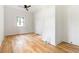 Bright bedroom with a ceiling fan and hardwood floors and a large window for ample natural light at 1554 Columbia Cir, Decatur, GA 30032