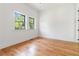 Bright bedroom with gleaming hardwood floors and two windows providing ample natural light at 1554 Columbia Cir, Decatur, GA 30032