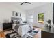 Bright bedroom with hardwood flooring, neutral decor, a ceiling fan and backyard views at 1554 Columbia Cir, Decatur, GA 30032