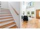 Bright and airy entryway and living space featuring hardwood floors, modern decor, and an open staircase at 1554 Columbia Cir, Decatur, GA 30032