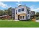 Beautiful new construction home with unique gray and white exterior, landscaped lawn, and modern design at 1554 Columbia Cir, Decatur, GA 30032