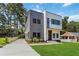 Modern two-story home with gray and white siding, black trim windows, and manicured front yard at 1554 Columbia Cir, Decatur, GA 30032