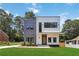Modern two-story home with gray and white siding, black trim windows, and lush green lawn at 1554 Columbia Cir, Decatur, GA 30032
