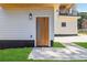 Home exterior featuring a wood front door, a green lawn, and a modern design with a balcony at 1554 Columbia Cir, Decatur, GA 30032