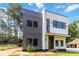 Contemporary two-story home with unique gray and white siding, complemented by black-framed windows at 1554 Columbia Cir, Decatur, GA 30032