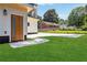 Landscaped lawn and modern home exterior with a wood door, driveway, and green grass at 1554 Columbia Cir, Decatur, GA 30032