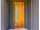 Stylish front door featuring a wood finish and a vertical glass insert, set in a modern gray frame at 1554 Columbia Cir, Decatur, GA 30032