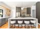 Modern kitchen with gray cabinetry, floating shelves, and a large quartz island with seating at 1554 Columbia Cir, Decatur, GA 30032